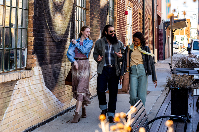 People walking down the street in West Village OKC