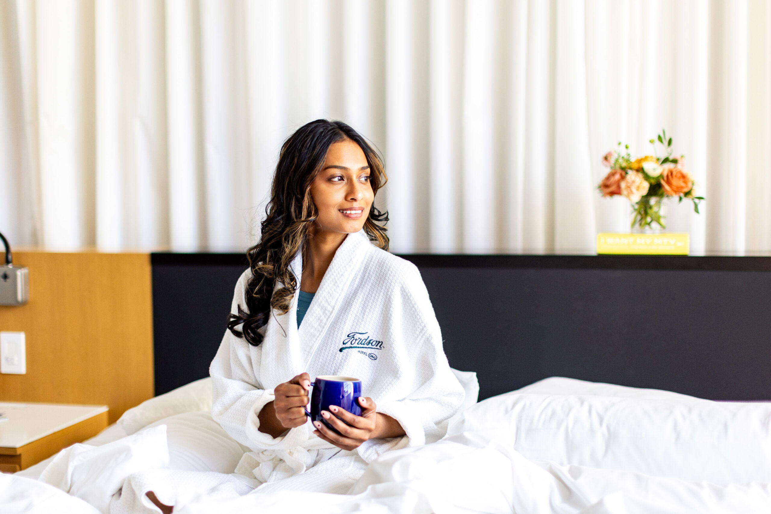 woman drinking coffee in bed